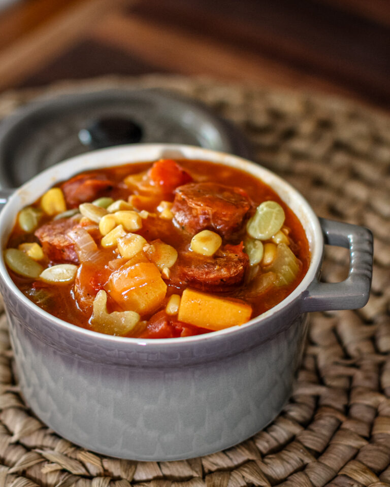 A colorful butternut squash stew with sausage.