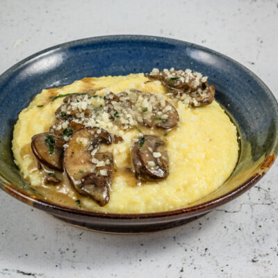 Sautéed mushrooms with butter and white wine over polenta.