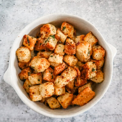 seasoned homemade croutons in a white pottery bowl