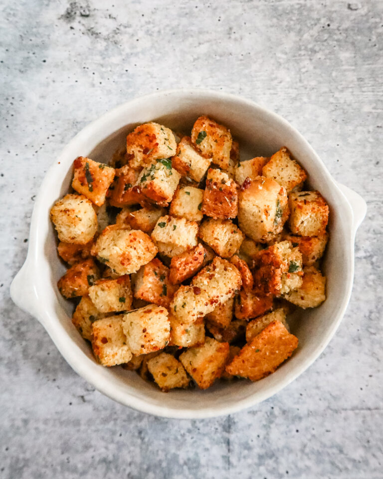 seasoned homemade croutons in a white pottery bowl