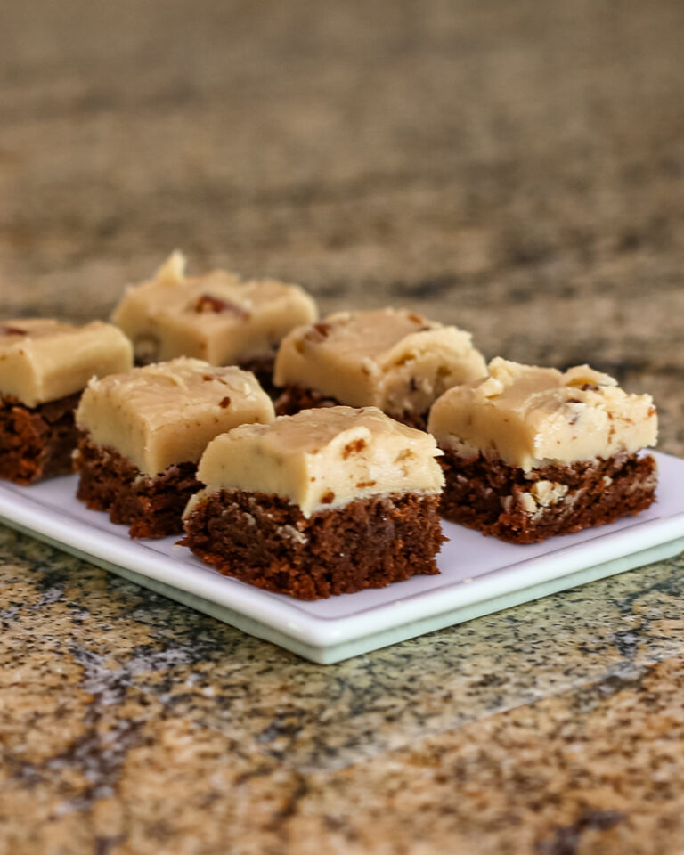Fudge brownie bars topped with creamy white chocolate and nuts on a small