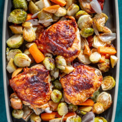 Roasted chicken thighs with roasted Brussels sprouts and carrots.