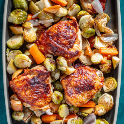 Roasted chicken thighs with roasted Brussels sprouts and carrots.