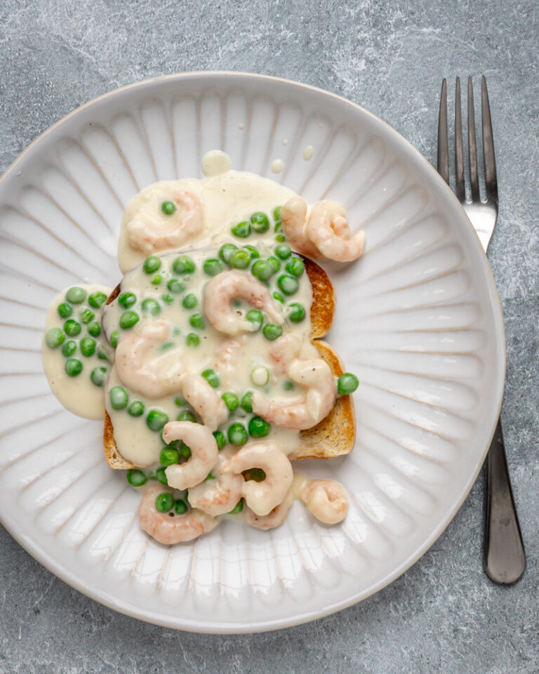 Shrimp wiggle with creamy sauce and peas over toast.
