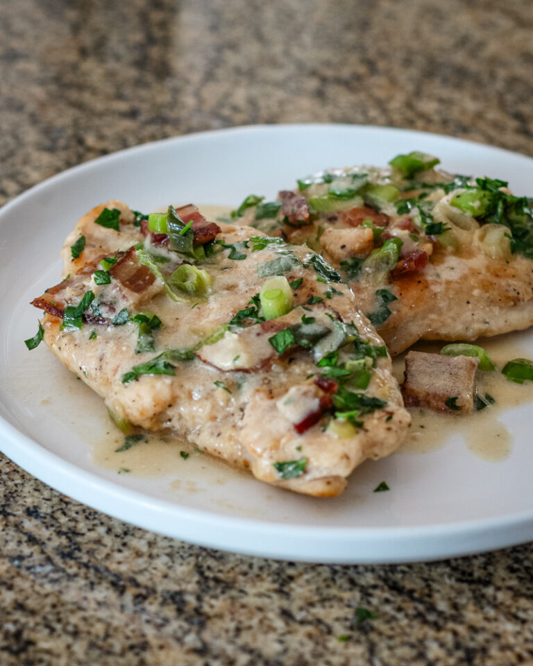 chicken with bacon and sour cream sauce on a serving plate
