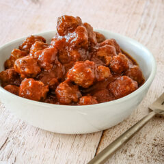 slow cooker barbecue meatballs appetizer in a bowl with a few on a plate