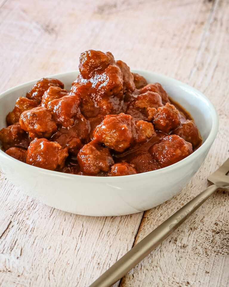 slow cooker barbecue meatballs appetizer in a bowl with a few on a plate