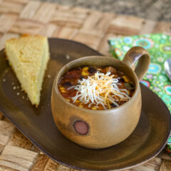 slow cooker chicken enchilada soup and cornbread on a serving tray