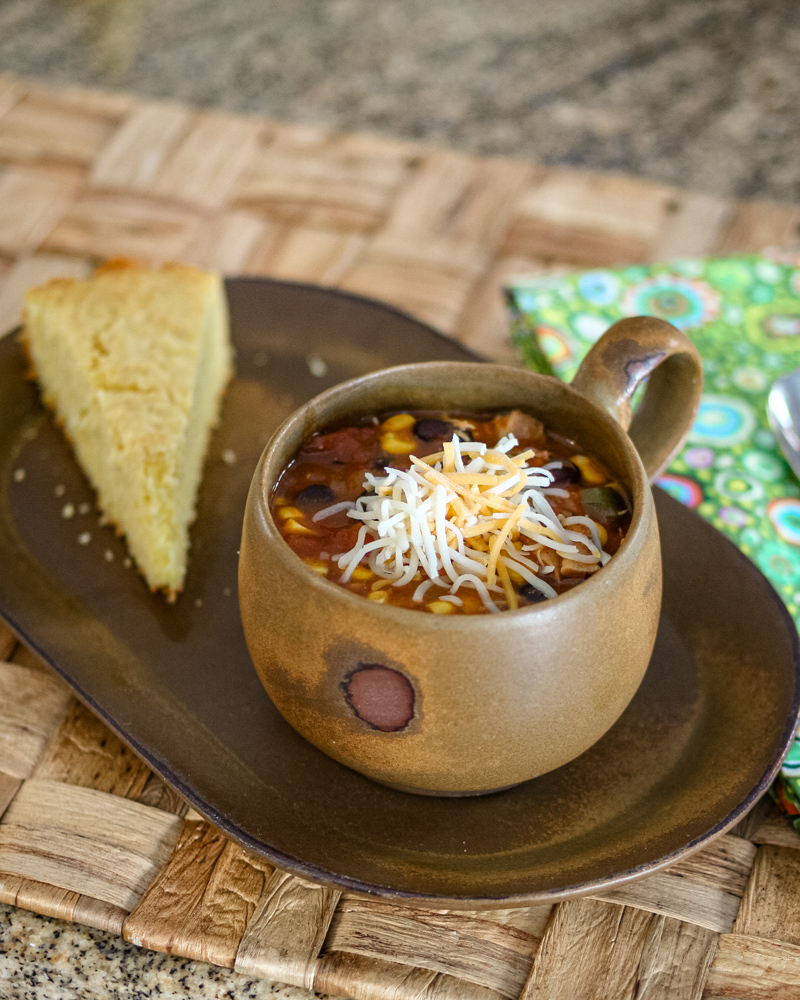 slow cooker chicken enchilada soup and cornbread on a serving tray