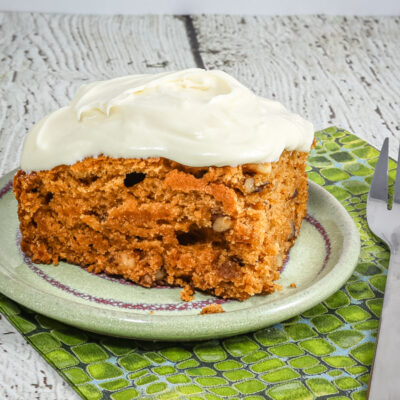 A slice of tomato soup cake on a small plate.