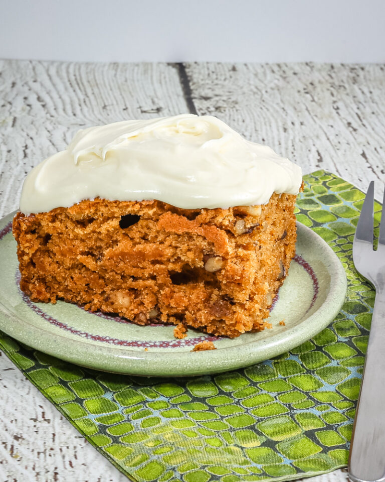 A slice of tomato soup cake on a small plate.