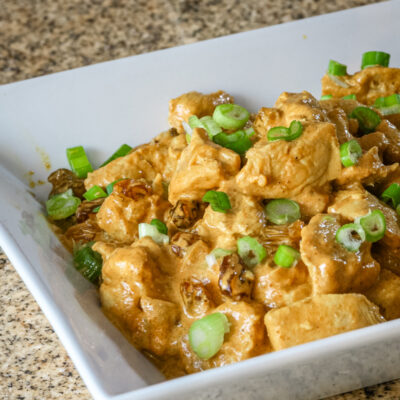 Creamy turkey curry with green onion garnish.