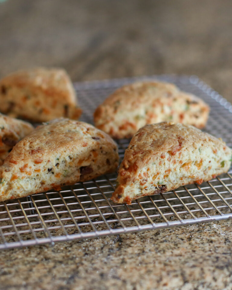 Baked bacon and cheddar scones on a cooling rack