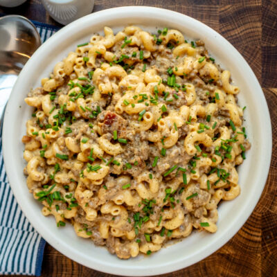 Creamy ground beef and macaroni casserole garnished with chopped chives.