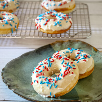 donuts with vanilla glaze and sprinkles on a plate