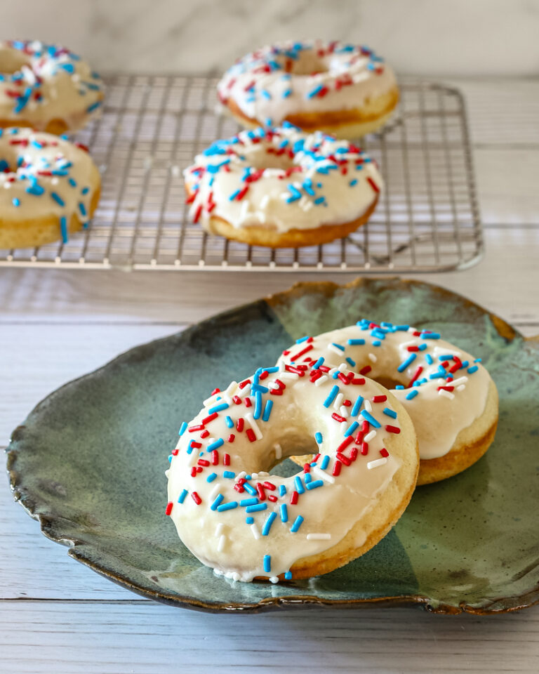 donuts with vanilla glaze and sprinkles on a plate