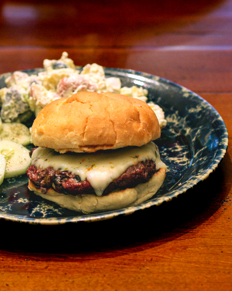 Juicy beef and bean cheeseburger with melted cheese on a soft bun.
