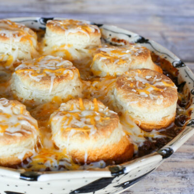 beef and bean casserole with biscuits and cheese topping