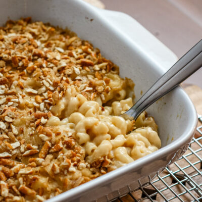 beer macaroni and cheese with a pretzel topping, in a baking dish