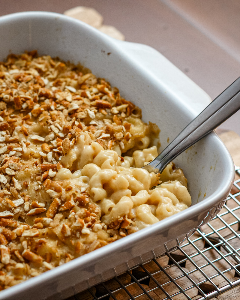 beer macaroni and cheese with a pretzel topping, in a baking dish