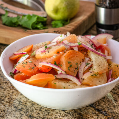 Beet salad with vinaigrette and red onions, in a serving bowl.