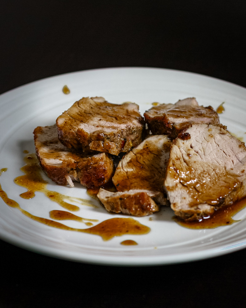 Pork tenderloin on a plate with bourbon and cola glaze.