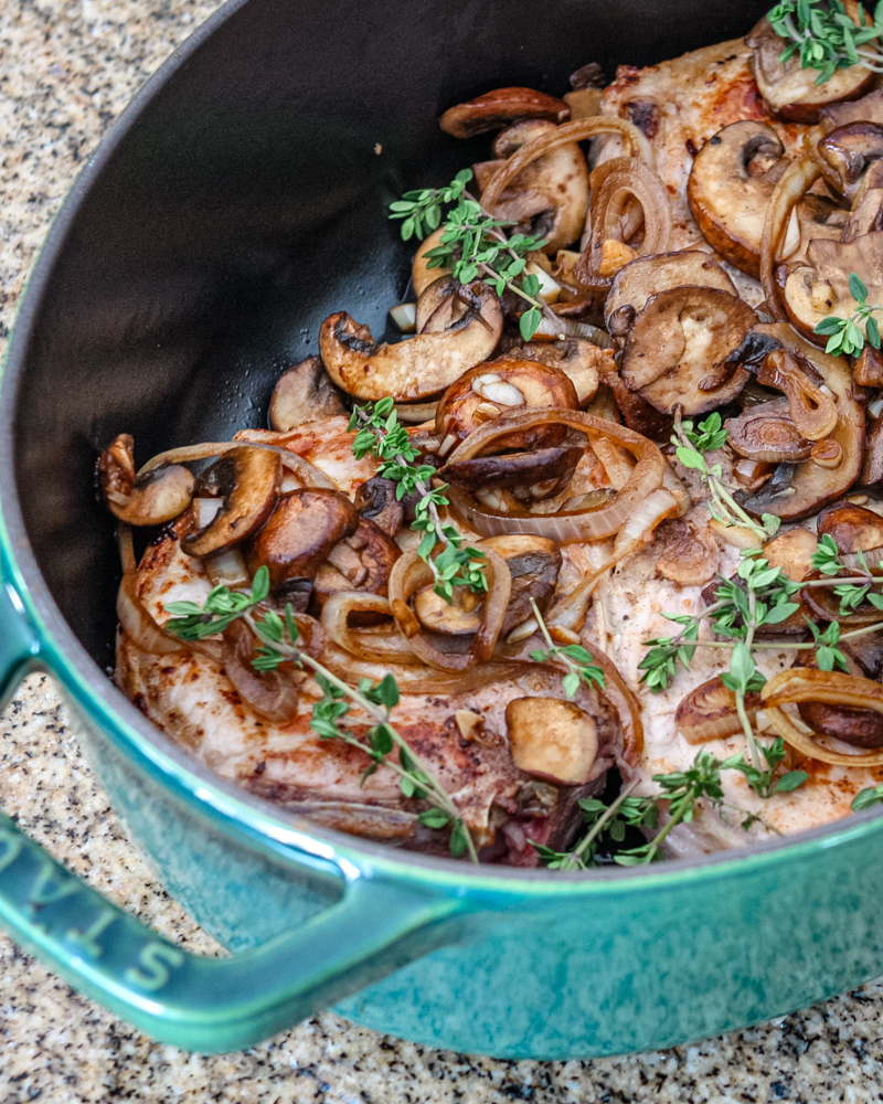 braised pork chops with mushrooms in a dutch oven