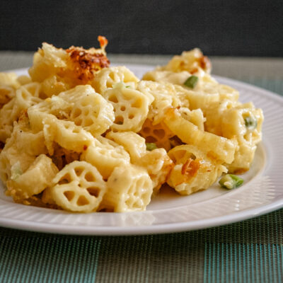 Cheesy wagon wheel pasta on a white plate.