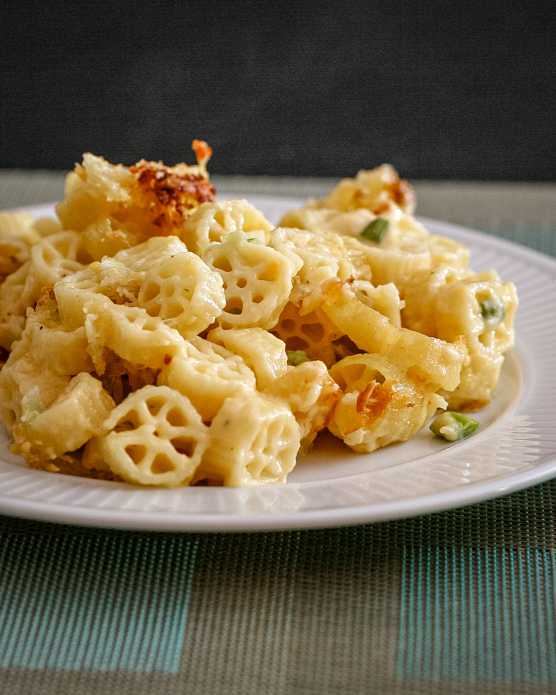 Cheesy wagon wheel pasta on a white plate.