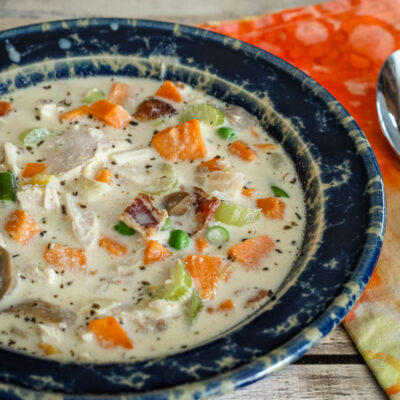 chicken and sweet potato chowder in a blue pottery bowl.