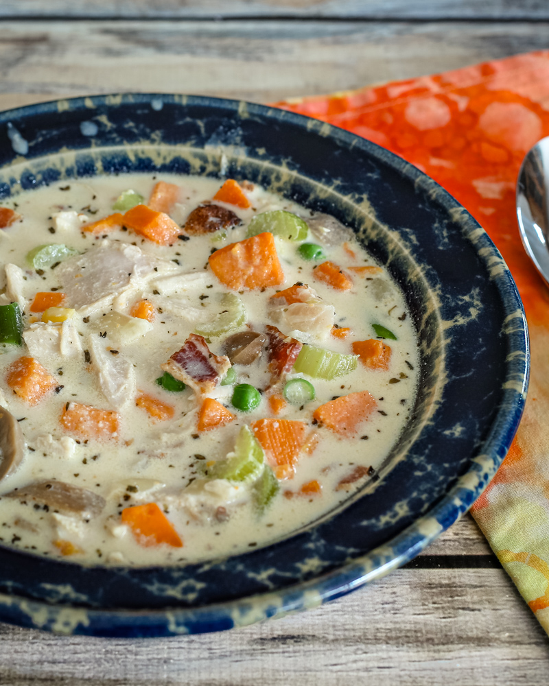 chicken and sweet potato chowder in a blue pottery bowl.