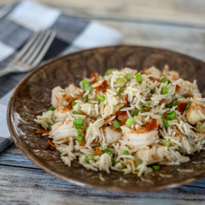 chicken rice pilaf with shrimp and bacon on a plate