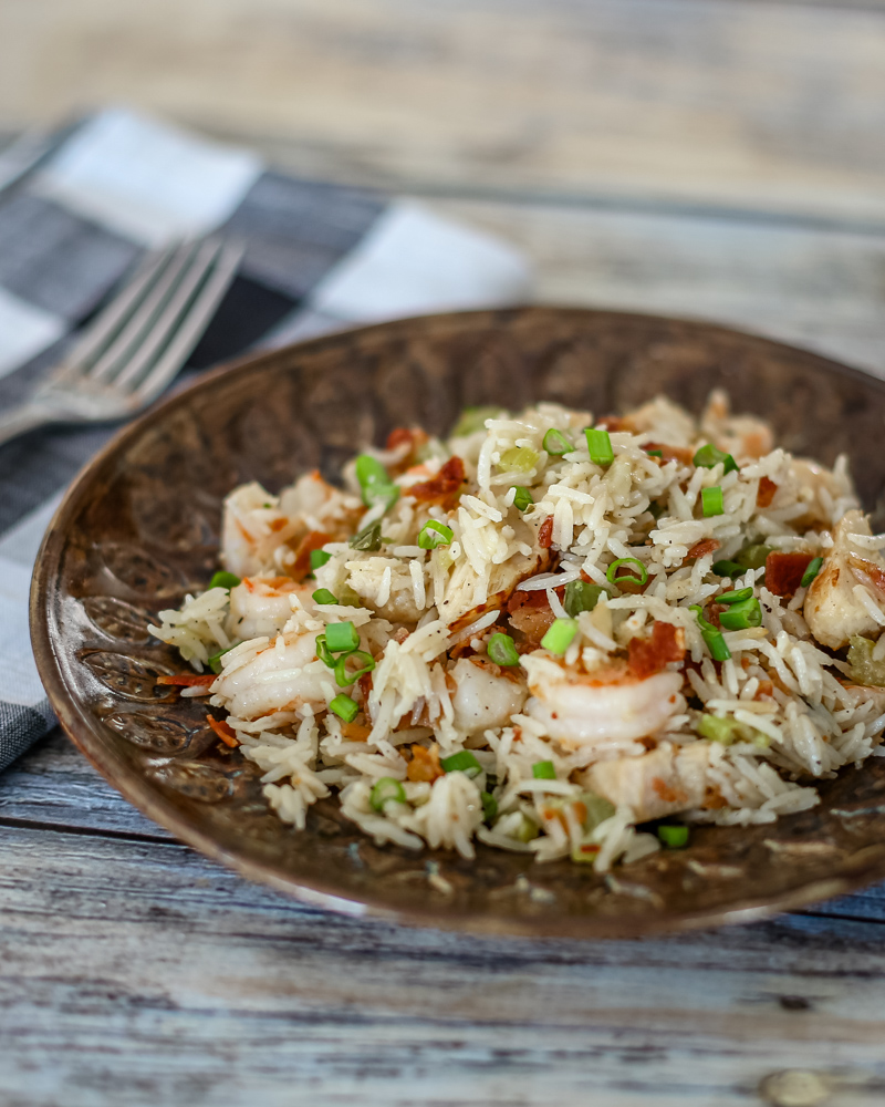 chicken rice pilaf with shrimp and bacon on a plate