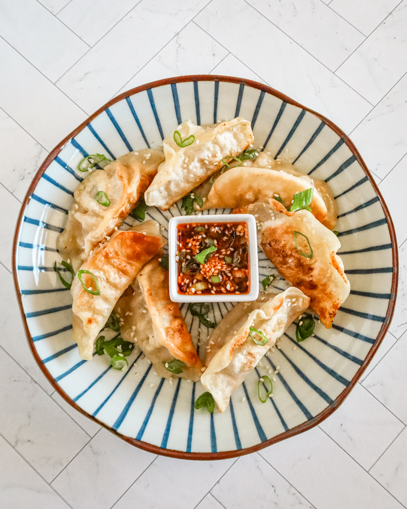 chili crisp dippping sauce with some fried dumplings
