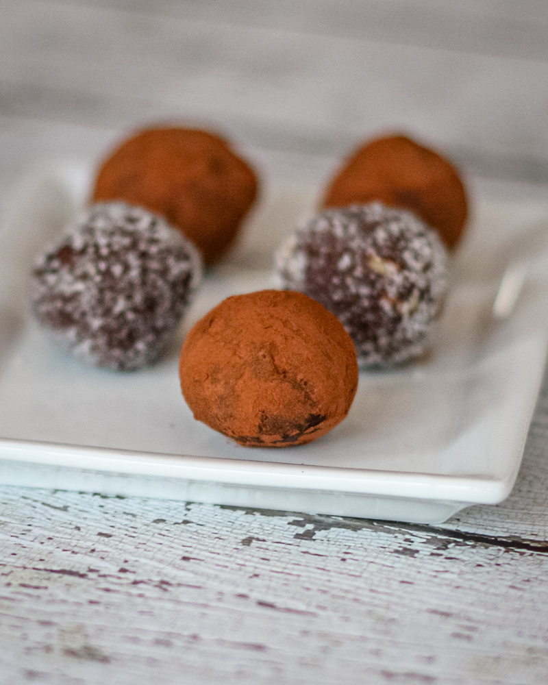 chocolate bourbon truffles on a plate with cocoa or sugar coating