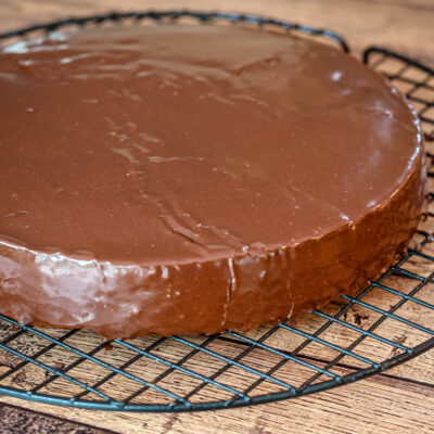 A cake layer covered with chocolate glaze