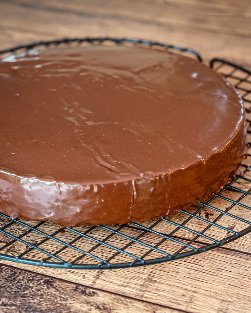 A cake layer covered with chocolate glaze