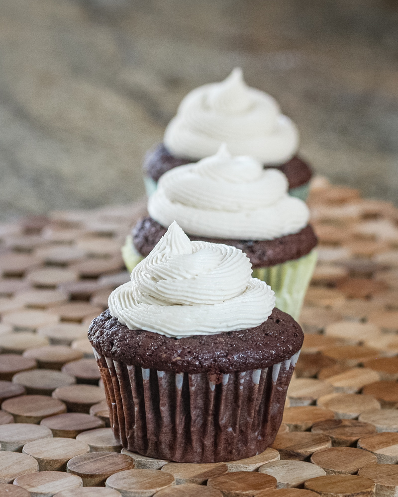 chocolate stout cupcakes on a wood placemat