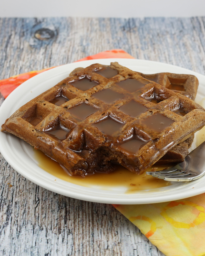 chocolate waffles on a plate with golden syrup