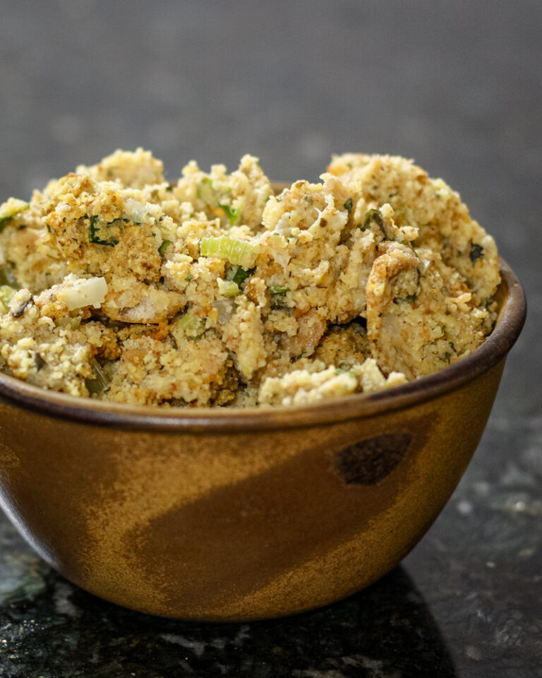 A serving bowl with cornbread and sausage dressing.