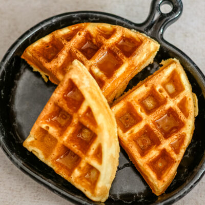 cornbread waffles on a luncheon plate with syrup