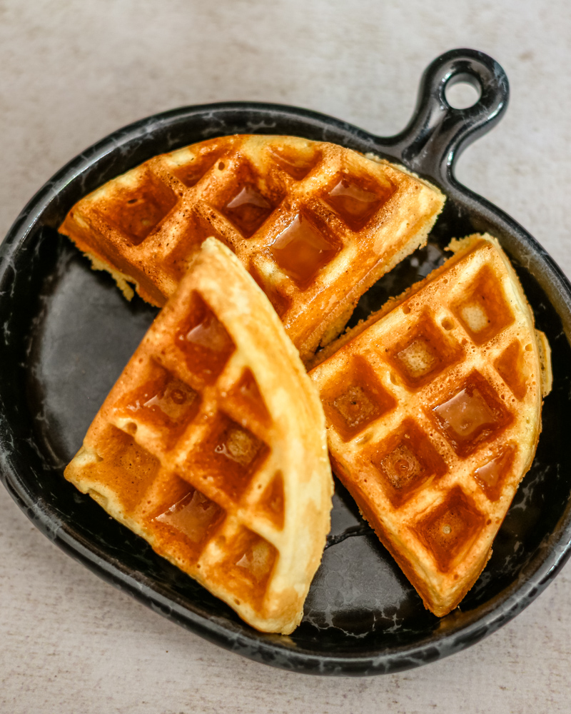 cornbread waffles on a luncheon plate with syrup