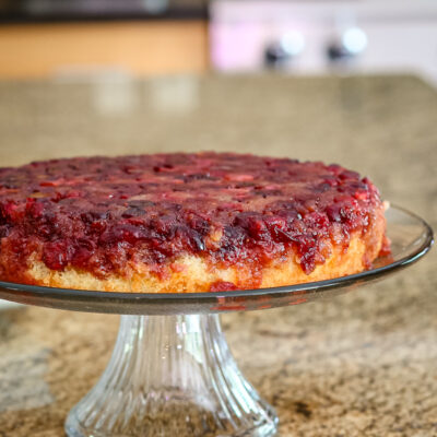 cranberry upside-down cake on a cake stand g