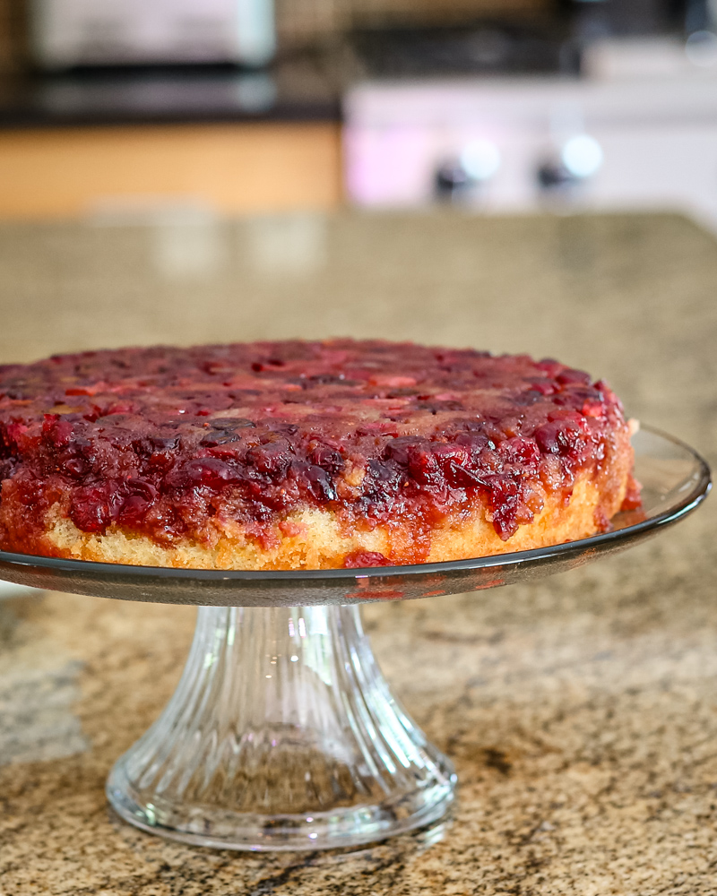 cranberry upside-down cake on a cake stand g