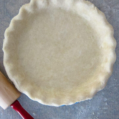 A cream cheese pie crust in a pie plate.