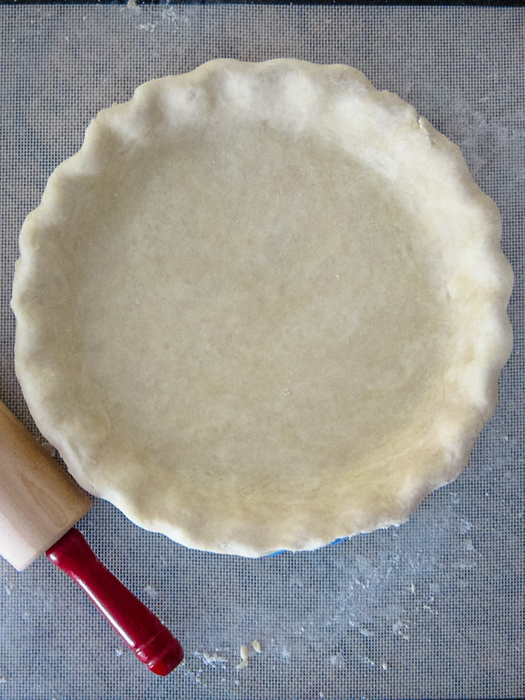 A cream cheese pie crust in a pie plate.