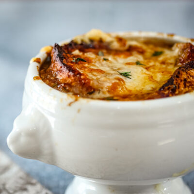 A lion's head bowl of French onion soup.