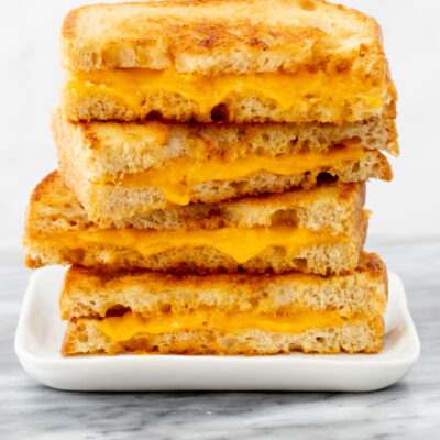 A stack of grilled cheese sandwich halves.