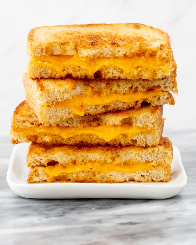 A stack of grilled cheese sandwich halves.
