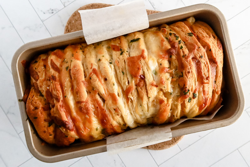 Baked pull apart garlic bread made with biscuits.